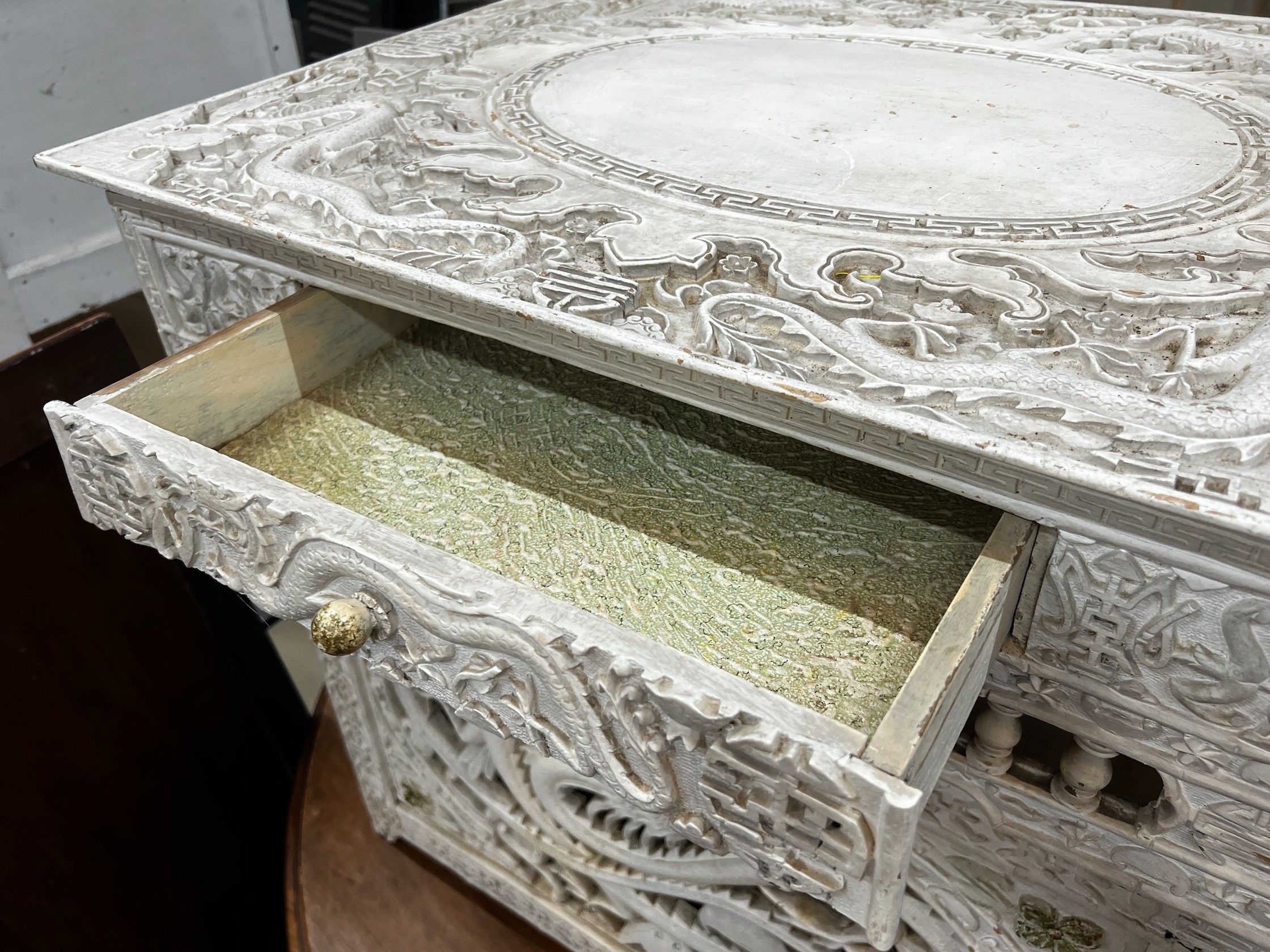 An early 20th century Chinese carved side table, width 75cm depth 56cm height 67cm (later painted)